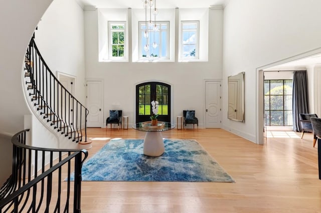 foyer featuring healthy amount of natural light, stairs, and a towering ceiling