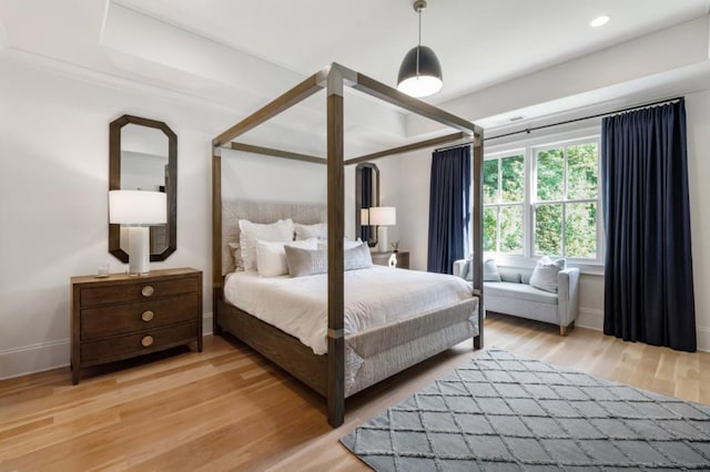 bedroom with light wood-style flooring and baseboards