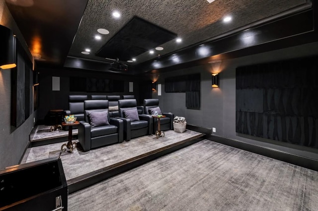 carpeted home theater room featuring recessed lighting, baseboards, and a raised ceiling