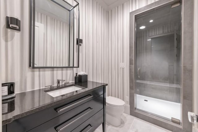 bathroom featuring toilet, a stall shower, and vanity