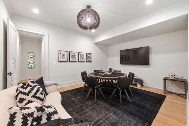 dining area with ornamental molding, wood finished floors, baseboards, and recessed lighting