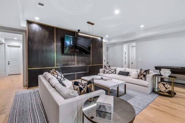 living area with wood finished floors and recessed lighting