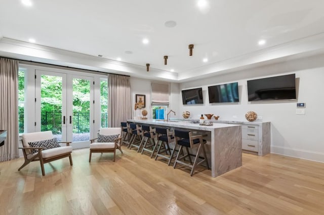 bar area featuring light wood-type flooring, ornamental molding, french doors, recessed lighting, and baseboards