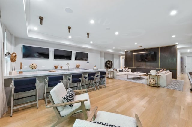 living area featuring light wood finished floors and recessed lighting