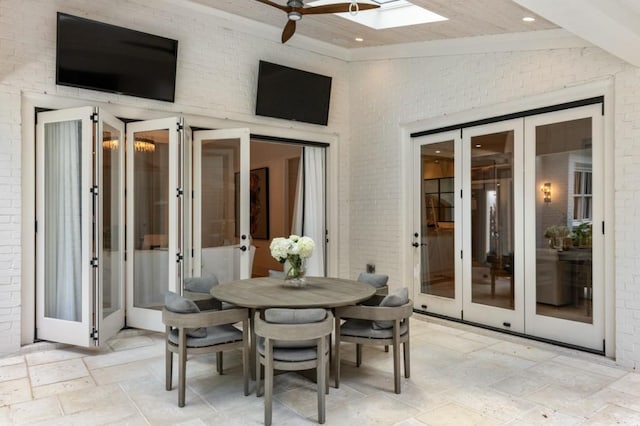 view of patio with french doors, ceiling fan, and outdoor dining space