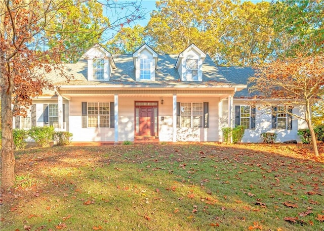 new england style home featuring a front lawn