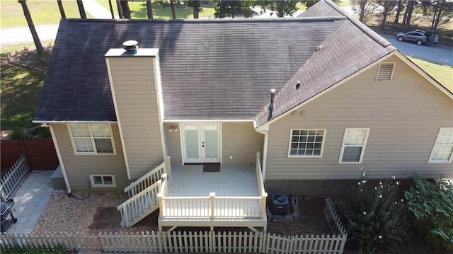 rear view of house with a wooden deck and french doors