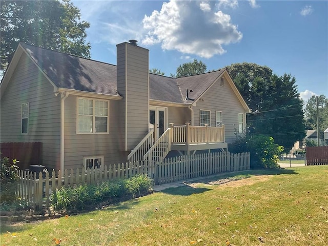 view of front of property with a wooden deck and a front lawn