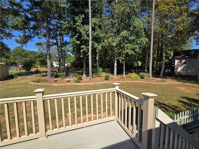 wooden terrace featuring a lawn