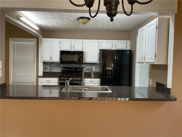 kitchen featuring white cabinets, a textured ceiling, backsplash, black appliances, and dark stone counters