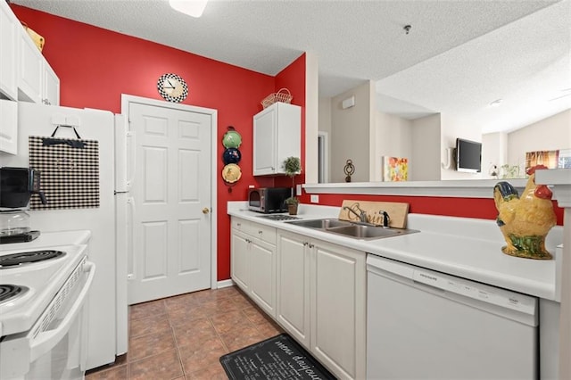 kitchen with a sink, a textured ceiling, white cabinetry, white appliances, and light countertops