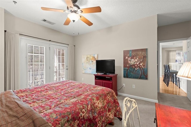 carpeted bedroom with visible vents, ceiling fan, baseboards, a textured ceiling, and access to outside