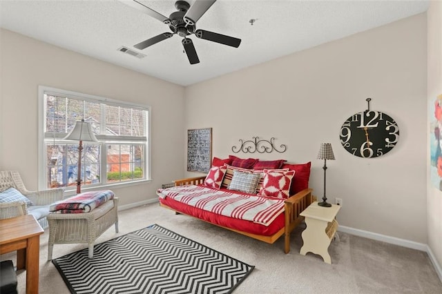 carpeted bedroom featuring visible vents, ceiling fan, a textured ceiling, and baseboards