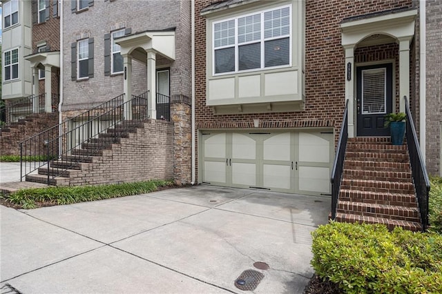1935 Cobblestone Cir NE, Brookhaven, GA 30319 - property entrance with driveway, brick siding, and a garage