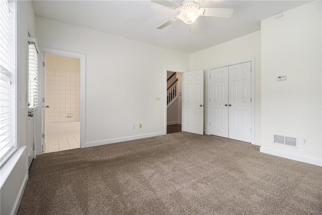 1935 Cobblestone Cir NE, Brookhaven, GA 30319 - unfurnished bedroom with carpet floors, a closet, ensuite bathroom, and ceiling fan