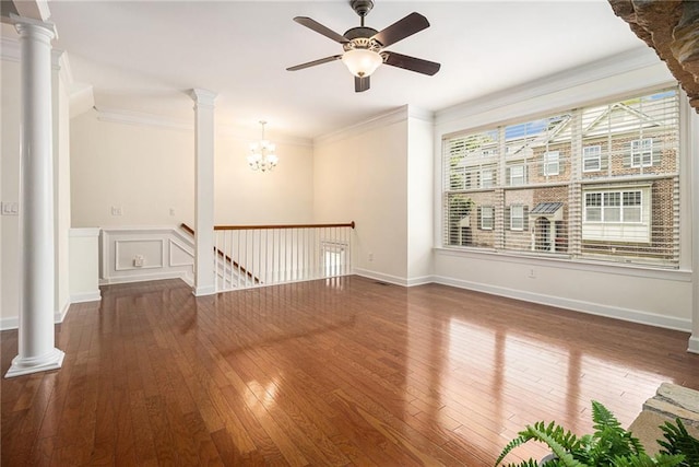 1935 Cobblestone Cir NE, Brookhaven, GA 30319 - empty room featuring wood-type flooring, ornate columns, crown molding, ceiling fan, and a chandelier