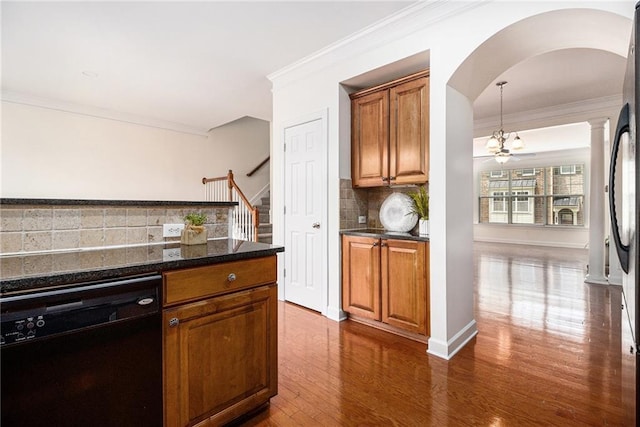 1935 Cobblestone Cir NE, Brookhaven, GA 30319 - kitchen featuring black dishwasher, arched walkways, tasteful backsplash, crown molding, and dark wood-style floors