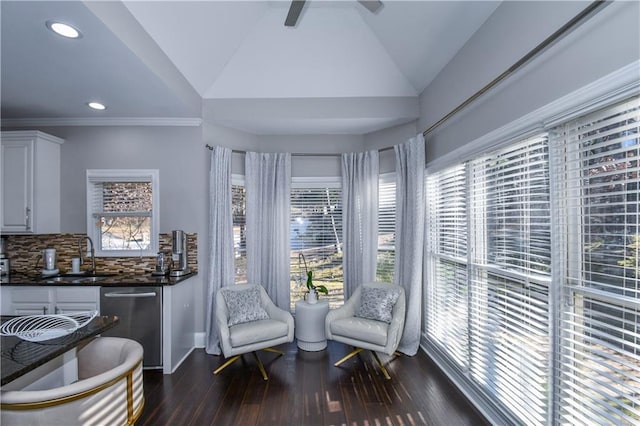 sitting room with ceiling fan, sink, dark hardwood / wood-style floors, and vaulted ceiling