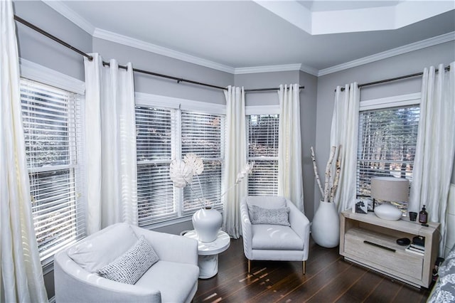 living area featuring dark hardwood / wood-style flooring, crown molding, and a healthy amount of sunlight