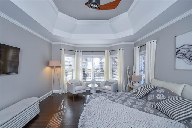 bedroom with ceiling fan, a raised ceiling, dark wood-type flooring, and crown molding