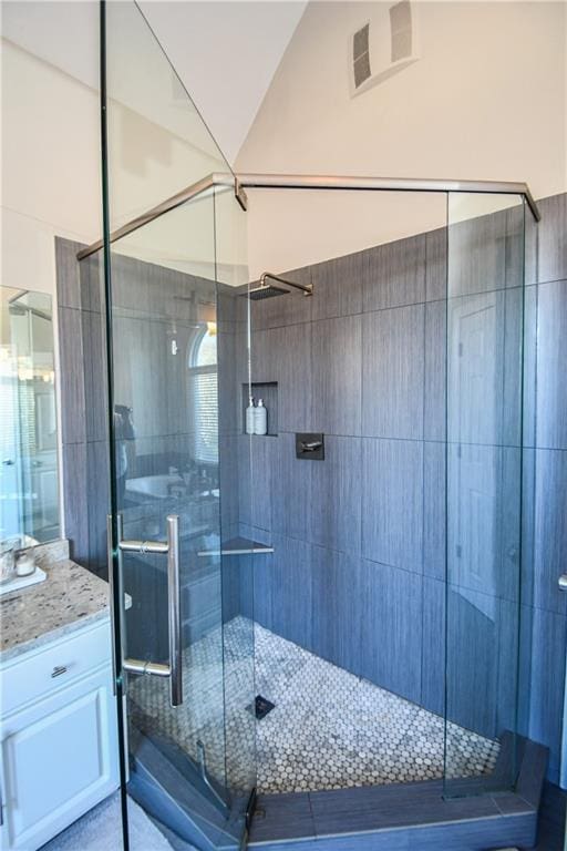 bathroom featuring vanity and an enclosed shower