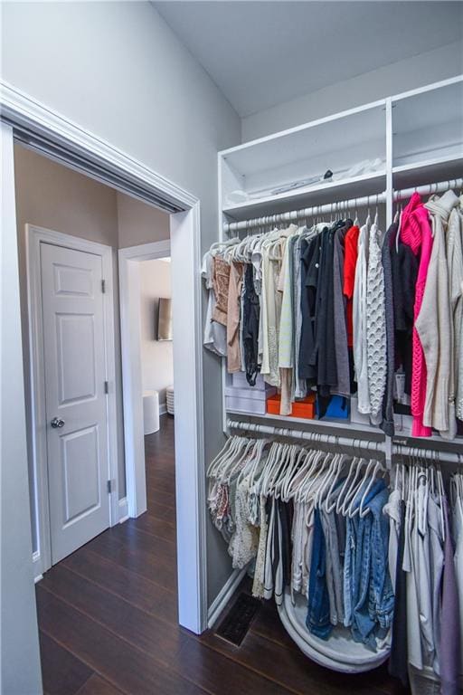 spacious closet with dark hardwood / wood-style floors