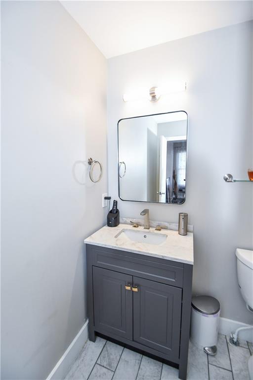 bathroom featuring vanity and toilet