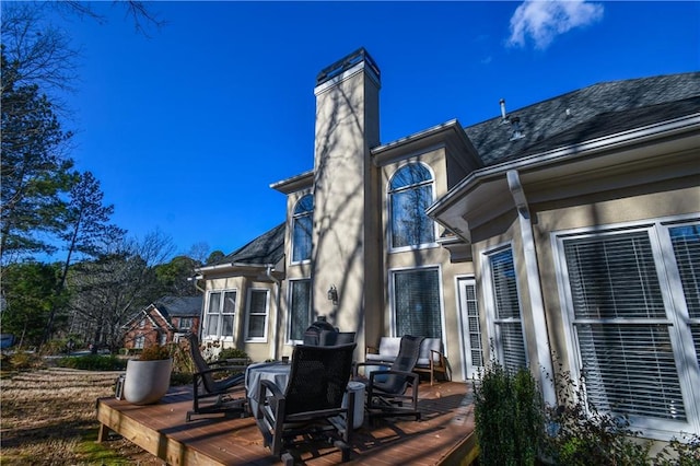 back of property with a wooden deck