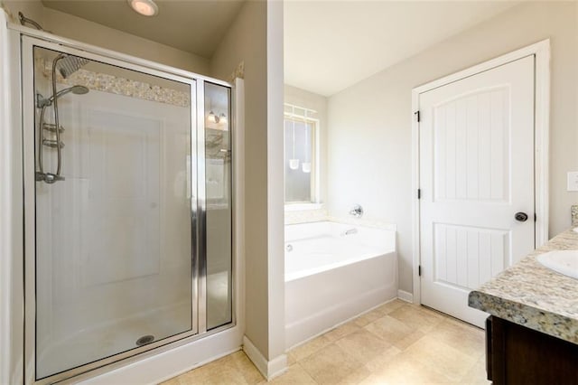 bathroom featuring vanity, a shower stall, and a bath