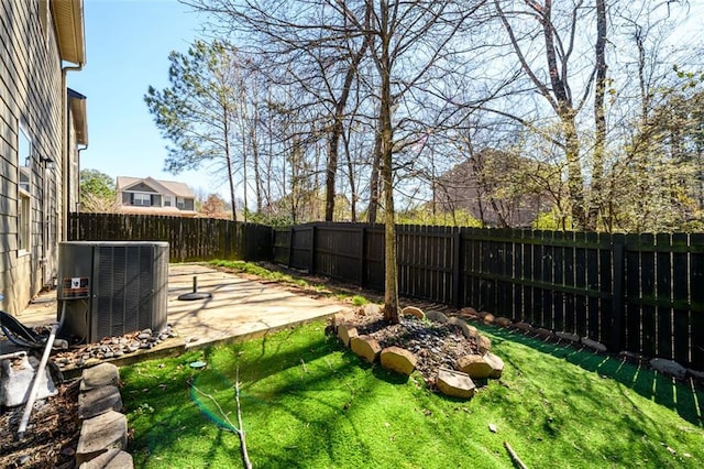 view of yard with a patio area, central AC, and a fenced backyard