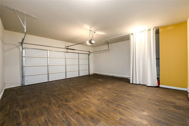 garage featuring baseboards and a garage door opener