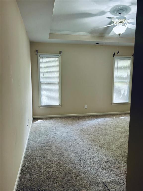 6605 New Ridge Ct, Cumming, GA 30041 - carpeted empty room with baseboards, a raised ceiling, ornamental molding, and ceiling fan