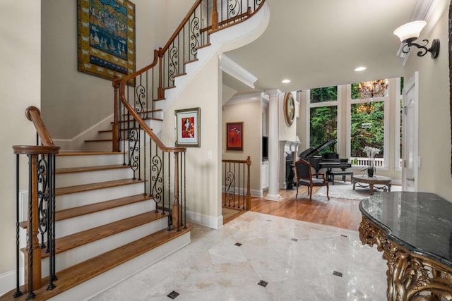 entrance foyer with hardwood / wood-style flooring and ornate columns