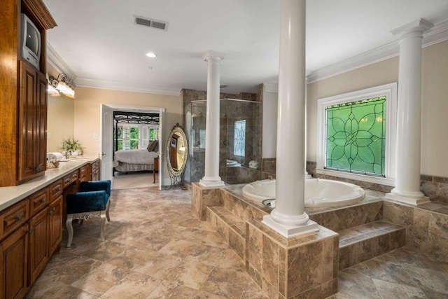 bathroom with tiled tub, vanity, ornate columns, and ornamental molding