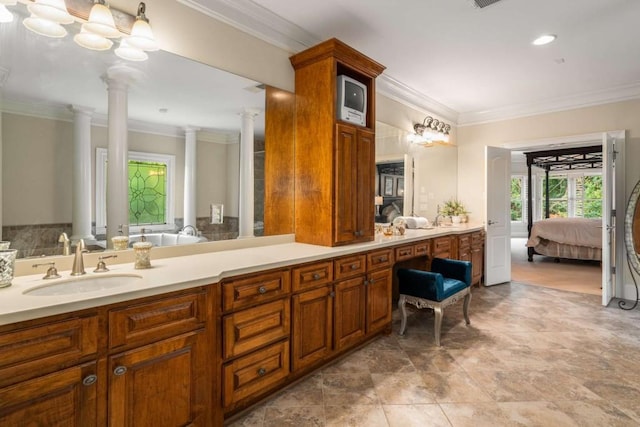 bathroom with vanity, ornamental molding, and ornate columns