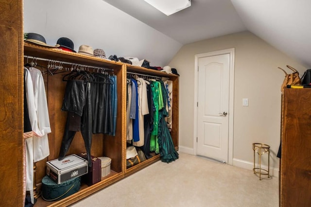 spacious closet with carpet floors and vaulted ceiling