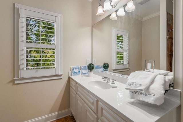 bathroom with a chandelier, vanity, crown molding, and a healthy amount of sunlight