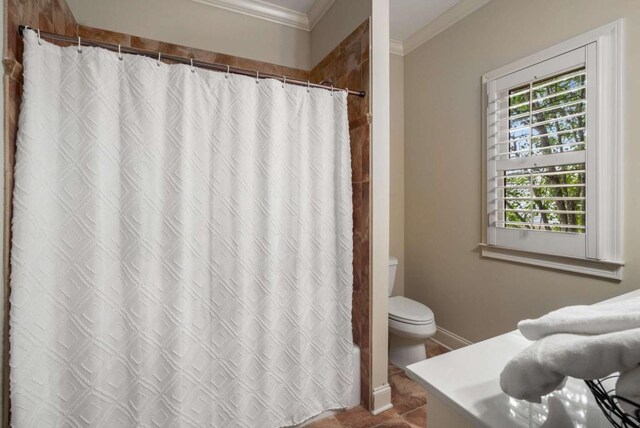 bathroom featuring ornamental molding and walk in shower