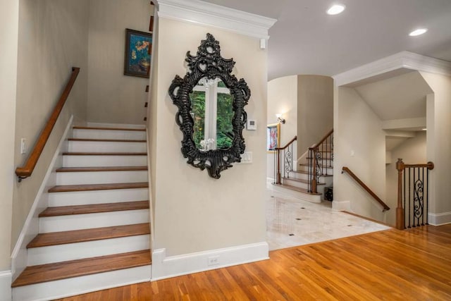 staircase with hardwood / wood-style floors