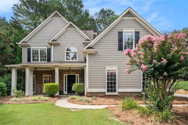 view of front of home featuring a porch and a front yard