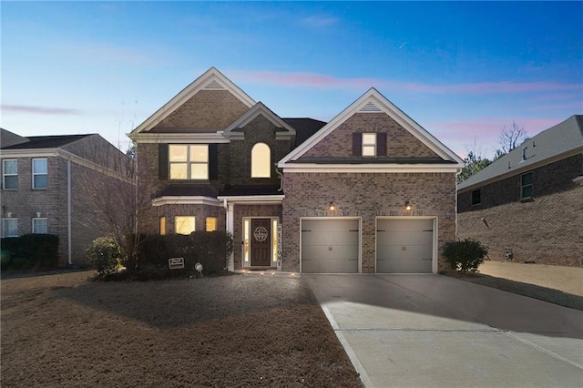 traditional home featuring a garage, brick siding, and driveway