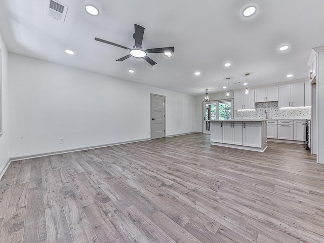 221 Wonewok Dr, Canton, GA 30114 - unfurnished living room featuring light wood-type flooring, recessed lighting, a ceiling fan, and a chandelier