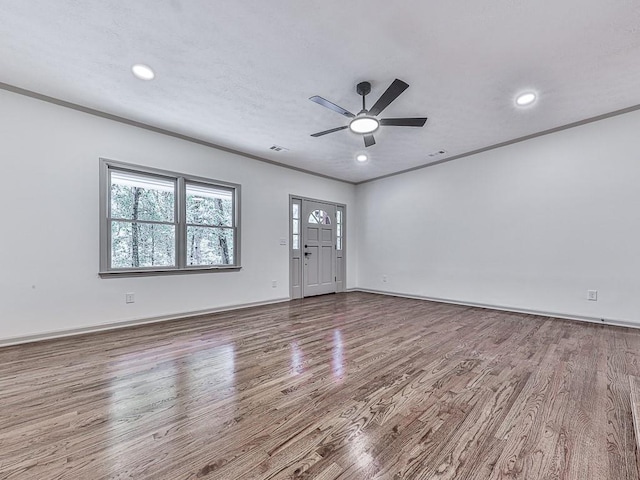 221 Wonewok Dr, Canton, GA 30114 - unfurnished living room with wood finished floors, ceiling fan, recessed lighting, and crown molding