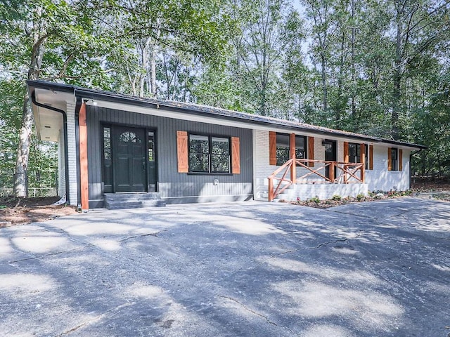221 Wonewok Dr, Canton, GA 30114 - view of front of home with a porch, concrete driveway, and brick siding