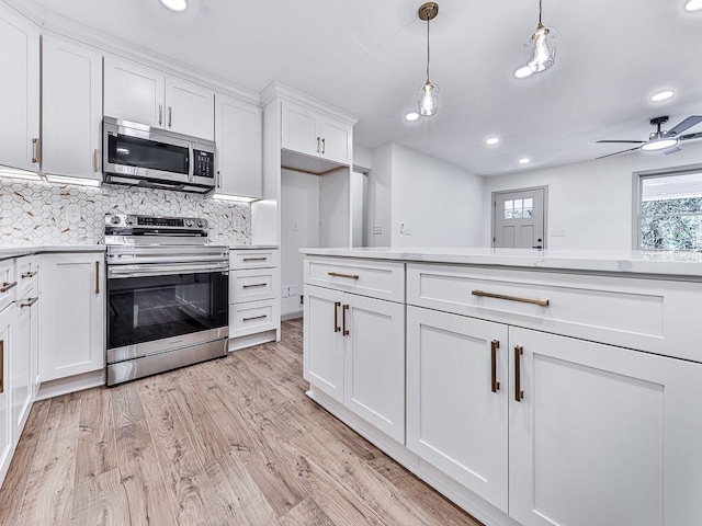 221 Wonewok Dr, Canton, GA 30114 - kitchen featuring stainless steel appliances, light countertops, backsplash, recessed lighting, and white cabinets