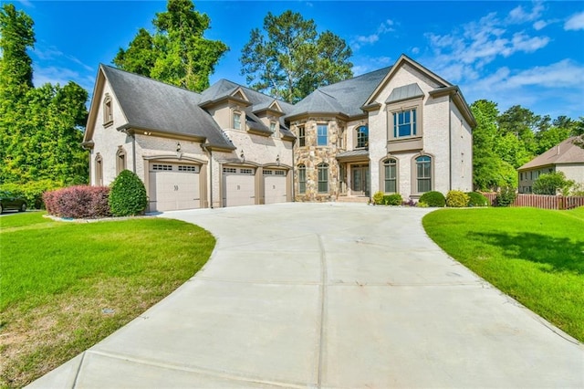 5121 Hope Ct SW, Lilburn, GA 30047 - french country home featuring driveway and stone siding