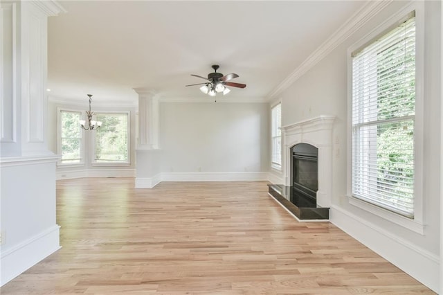 5121 Hope Ct SW, Lilburn, GA 30047 - unfurnished living room with a glass covered fireplace, healthy amount of natural light, a chandelier, and crown molding