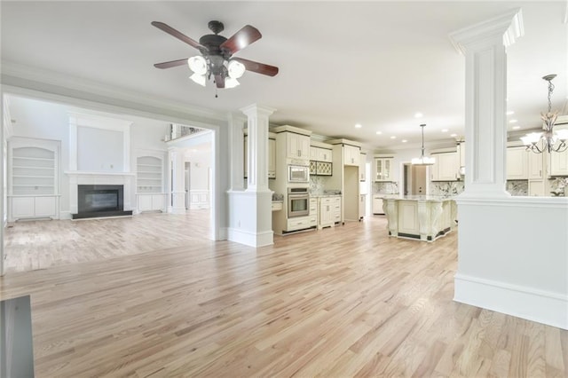 5121 Hope Ct SW, Lilburn, GA 30047 - unfurnished living room with decorative columns, a ceiling fan, light wood-type flooring, recessed lighting, and a glass covered fireplace