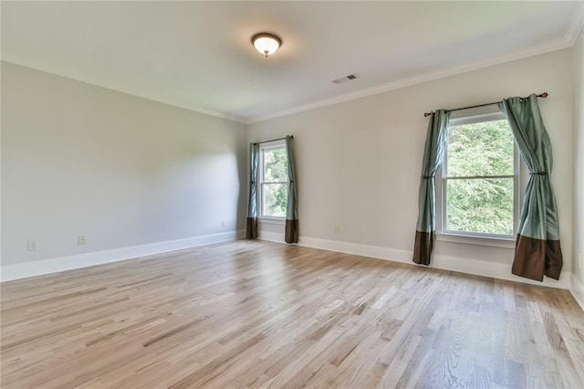 5121 Hope Ct SW, Lilburn, GA 30047 - empty room featuring light wood-style floors, plenty of natural light, ornamental molding, and baseboards