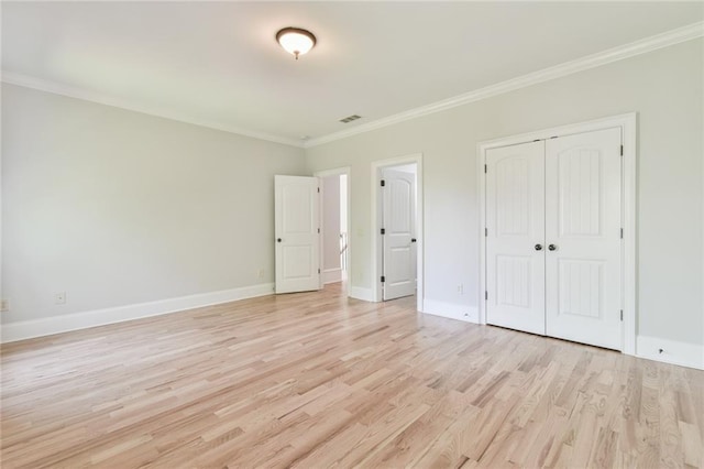 5121 Hope Ct SW, Lilburn, GA 30047 - unfurnished bedroom featuring light wood-type flooring, a closet, ornamental molding, and baseboards